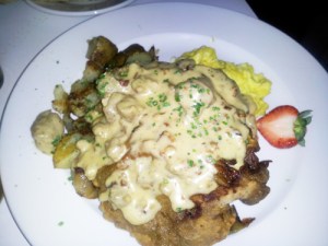 Chicken Fried Steak with two eggs scrambled, country gravy, smashed potatoes and toast