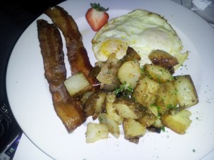 two eggs over medium with smoked bacon, chive potatoes and toast